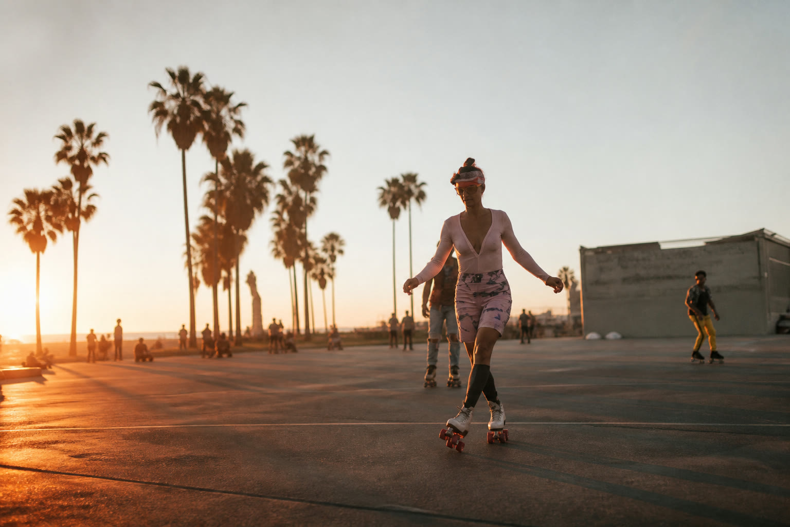 Skaters on the Venice Beach boardwalk at golden hour